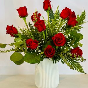 One dozen long stemmed roses with mixed greens and filler